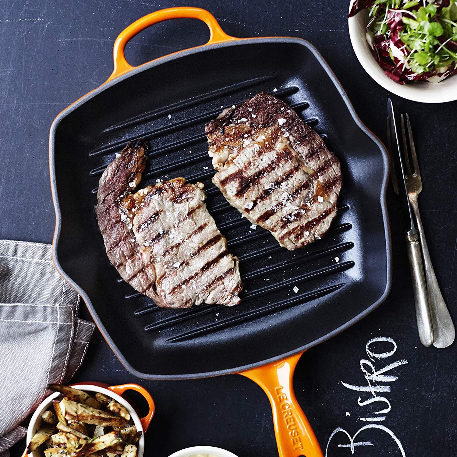 https://www.consiglioskitchenware.com/cdn/shop/products/Le_Creuset_Flame_Square_Skillet_Grilling_Canada_753136b7-4d06-406f-97f7-64d4fcf60c3e_1500x1500.jpg?v=1605128216